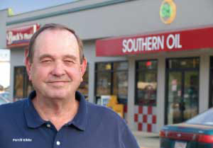 Ferrill Gibbs in front of one of his gas stations